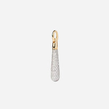 Jewelry pendant with gold top and silver teardrop design on a light grey background