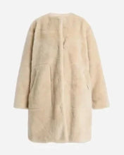 A long beige sherpa fur coat on a light grey background