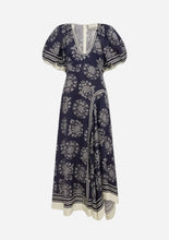 A navy blue midi dress with a white floral print, featuring puff sleeves, a V-neckline, and a cream-colored hem and trim details.