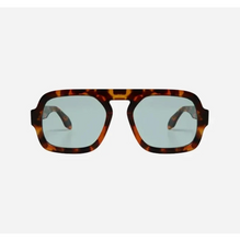 Sunglasses with tortoiseshell frame and blue lenses on a light grey background