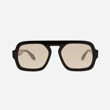 Black sunglasses with beige lenses on a light grey background