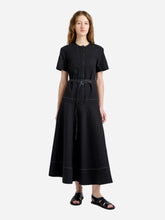 Woman wearing a black dress on a white background