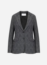 A  blazer in a dark gray and black micro-check plaid pattern, featuring lapels, a two-button front, and flap pockets, shown against a plain light gray background.