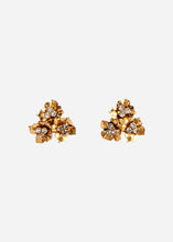 Pair of gold floral earrings with gemstones on a light grey background