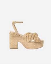 Beige woven sandal with platform sole and ankle strap a light grey background