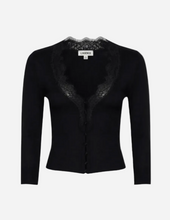 A black knit cardigan sweater with a lace-trimmed V-neckline and front button closure, shown on a light grey background.