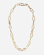 Gold loop chain necklace on a light gray background