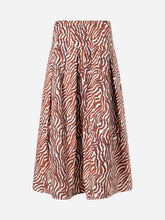 Red, brown, and white zebra patterned skirt on a light grey background