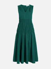 Green dress on a light grey background
