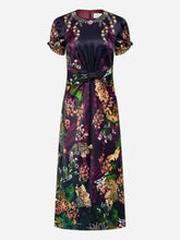A floor-length dress with a vibrant multicolor floral and botanical print, featuring short puff sleeves and tie waist, shown against a light gray background.