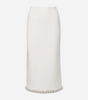 A midi length skirt with beading at the hem, displayed on a light grey background