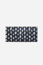 A rectangular clutch bag with a black background and an all-over colorful patterned print, shown against a light grey white background.