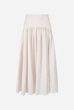 Cream colored maxi skirt on a light grey background