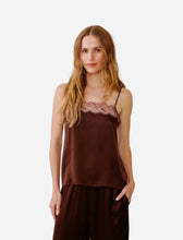 A dark brown silk camisole top with a lace underband  against a light gray studio background.