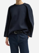 A dark blue oversized crewneck  on a light gray background
