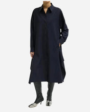 A long navy blue shirt dress with a pointed collar and buttons down the center