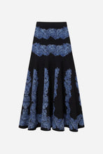 Black skirt with blue patterned detailing on a light grey background