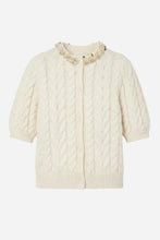 An off-white cable-knit short sleeve cardigan sweater with a ruffled collar decorated with small gold and white beads, shown against a light grey background.