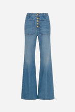 medium blue flared jeans with five gold buttons and large front pockets on a light grey background