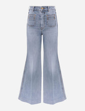 Light blue high rise flared jeans with front pockets on a light grey background
