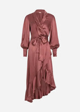 A long-sleeved silk wrap dress in a mauve color, featuring a shawl collar, self-tie waist belt, and an asymmetrical ruffled hemline, shown against a light grey background.